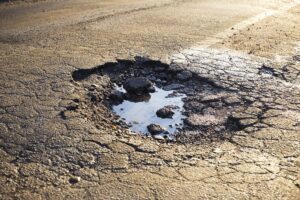 Pothole road damage caused by rains