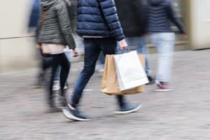 Photo of couple walking on the street with the man on the outside - photo accompanies an article about the sidewalk rule which became trending on TikTok.